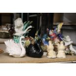 A COLLECTION OF BIRD FIGURINES TO INCLUDE SWANS, A PARROT, WOODPECKER, ETC