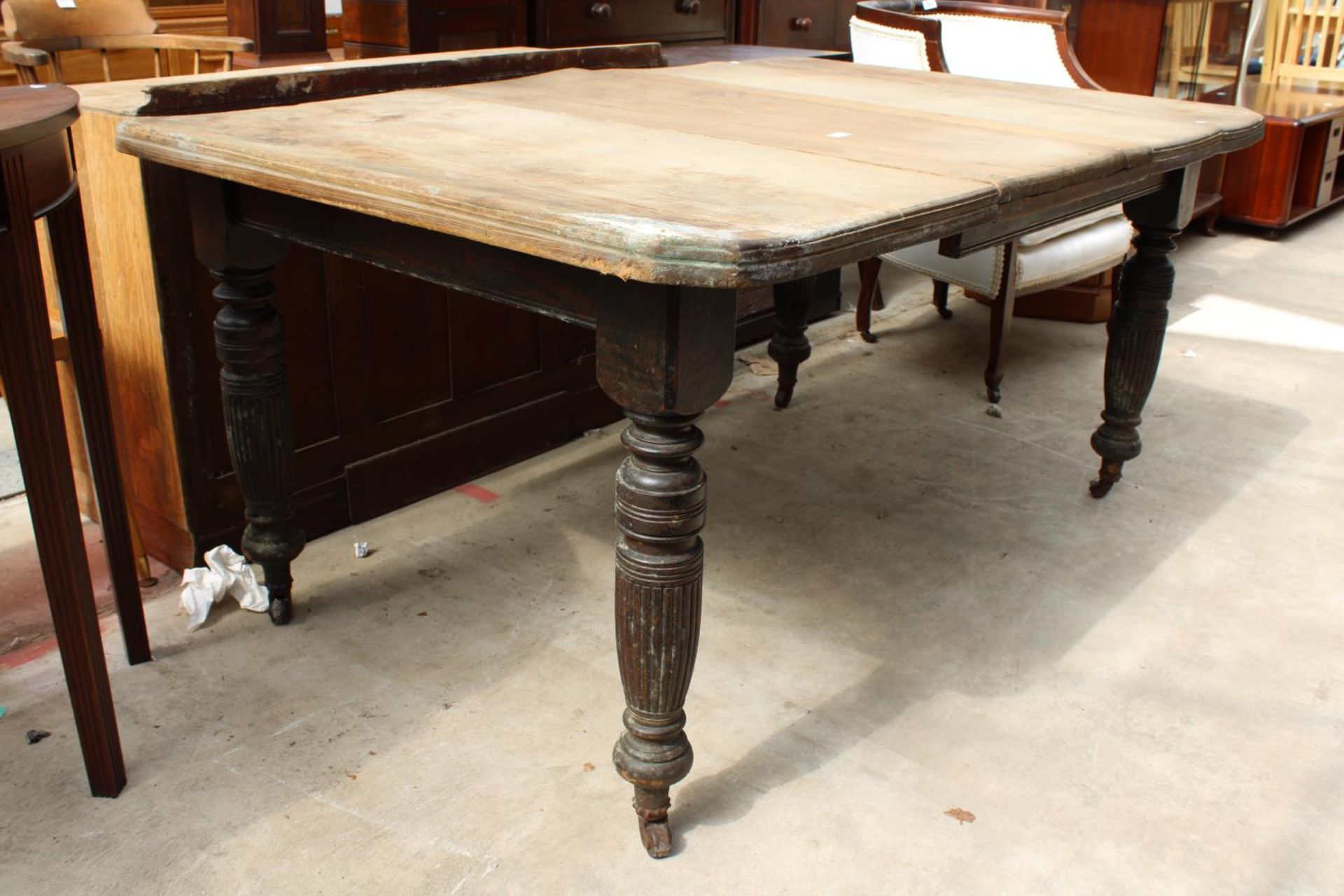 A LATE VICTORIAN SCRUB TOP WIND-OUT DINING TABLE WITH CANTED CORNERS ON TURNED AND FLUTED LEGS - Image 2 of 3