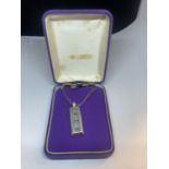 A SILVER INGOT AND CHAIN IN A PRESENTATION BOX