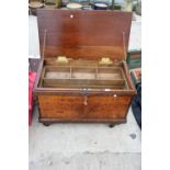 A VINTAGE WOODEN TOOL CHEST WITH FOUR WHEELS TO THE BASE