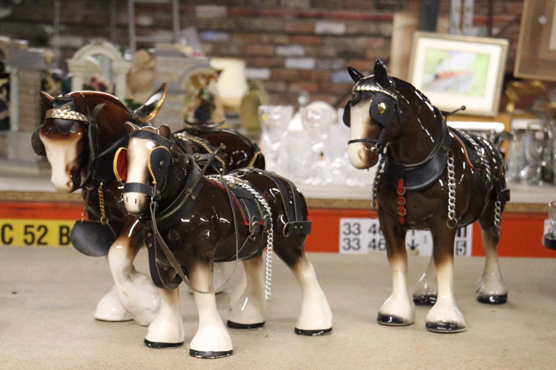 THREE LARGE CERAMIC SHIRE HORSE FIGURES WITH HARNESSES