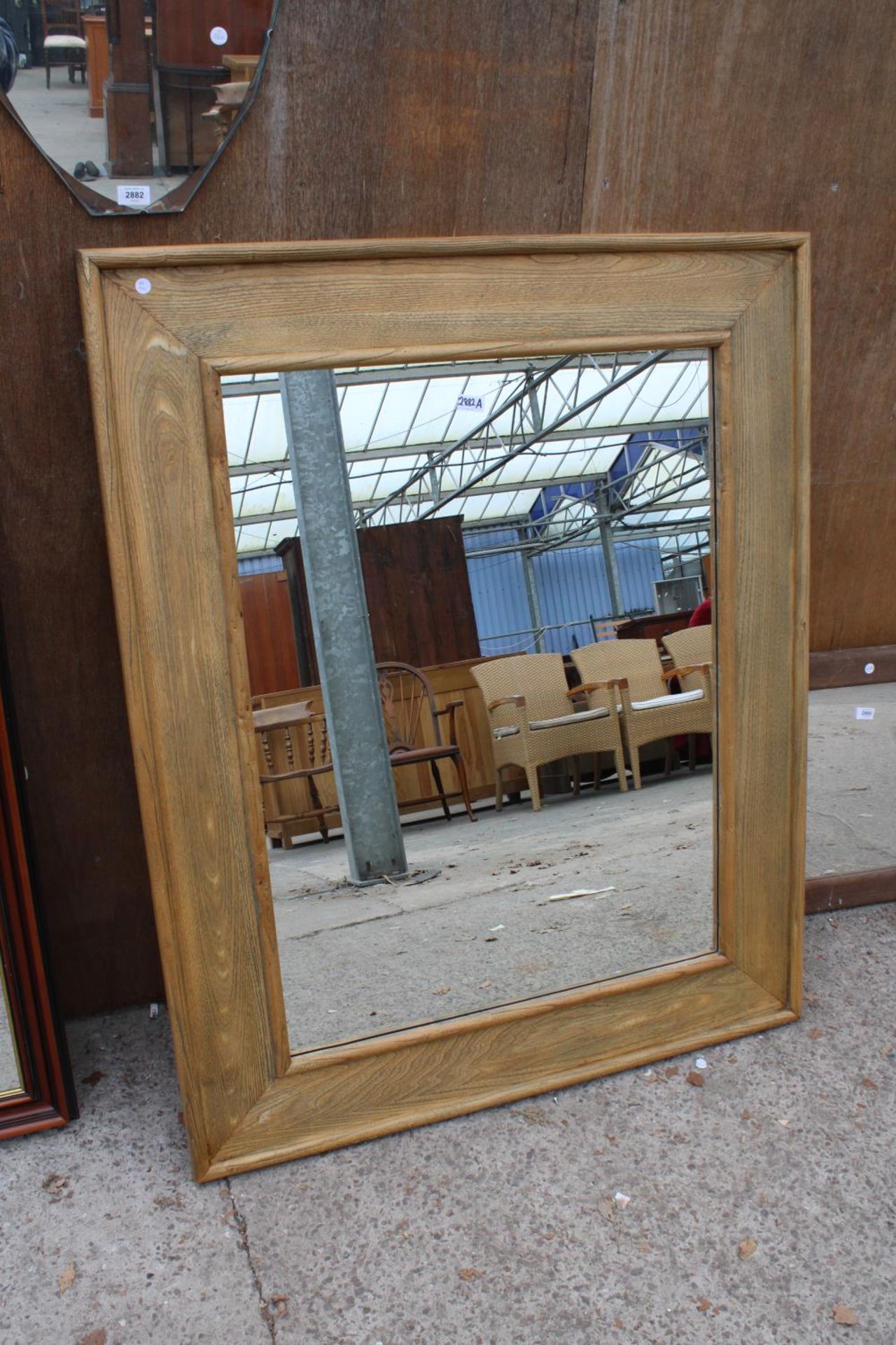 A MODERN OAK FRAMED WALL MIRROR, 51" X 42"