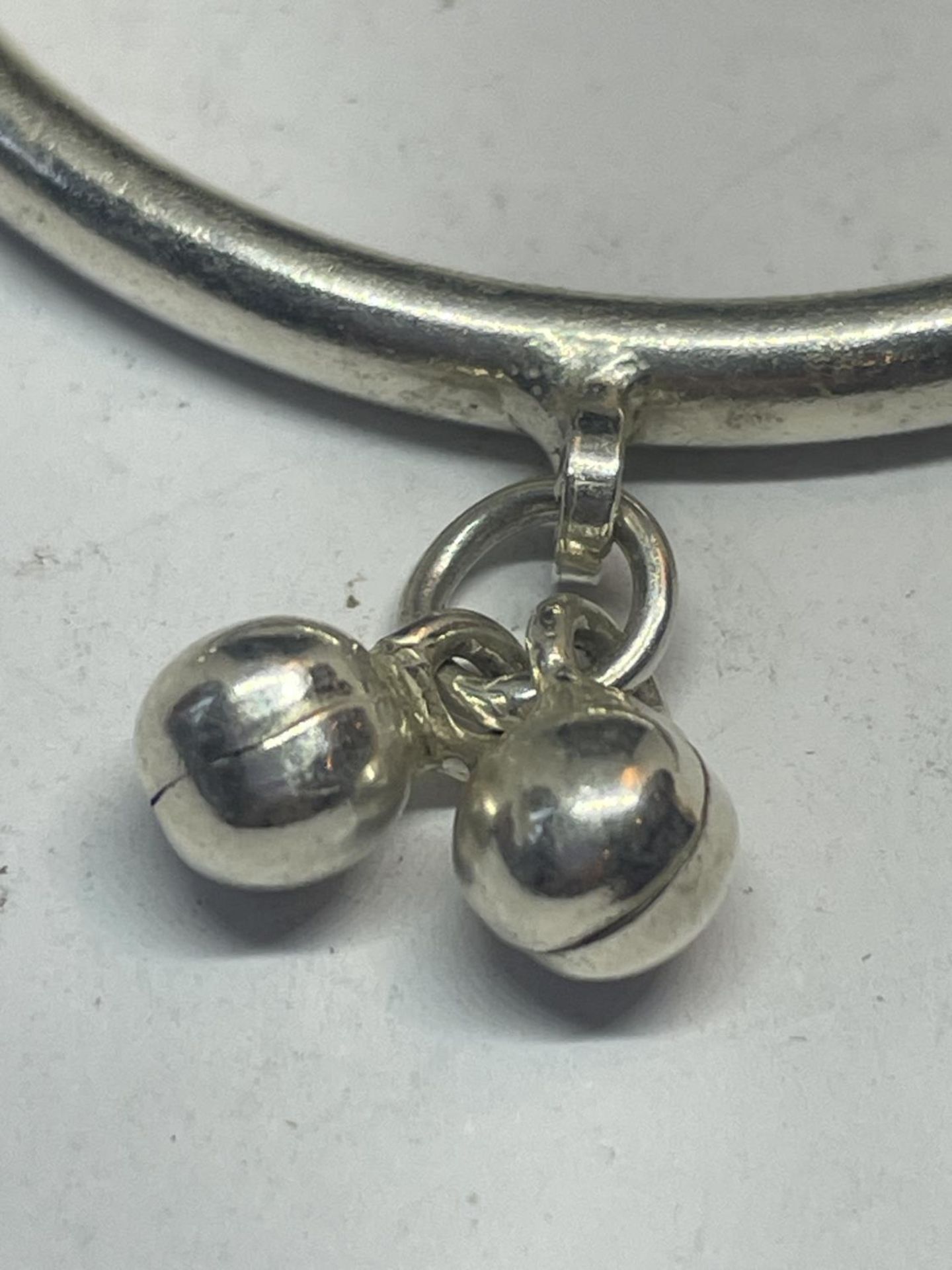 A BABY'S SILVER BANGLE WITH CHARMS - Image 2 of 3