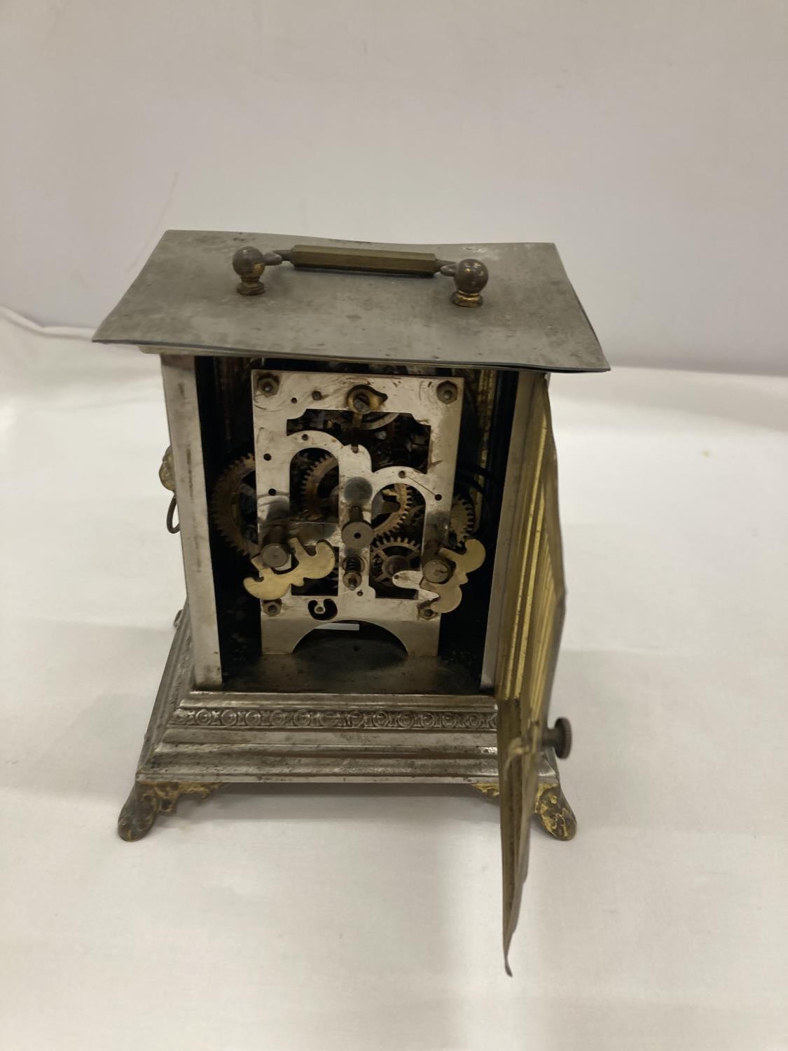 AN OFFICER'S ALARM CLOCK WITH BRASS DECORATION AND LION HEADS TO THE SIDE - Image 3 of 4