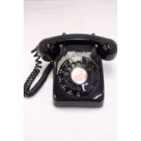 A VINTAGE BLACK TELEPHONE WITH DIAL