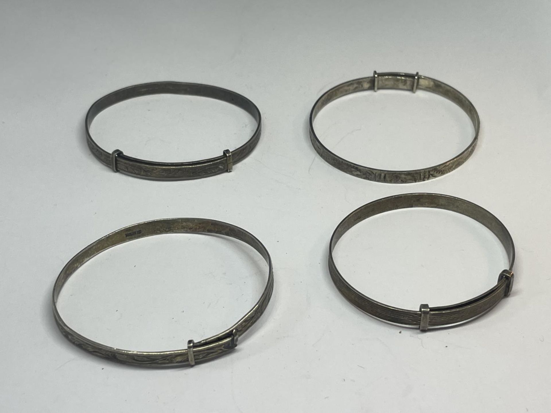 FOUR SILVER BABY BANGLES