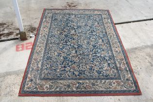 A RED AND BLUE PATTERNED RUG MADE IN BELGUIM