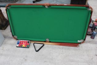 A TABLE TOP POOL TABLE, CUES AND BALLS ETC
