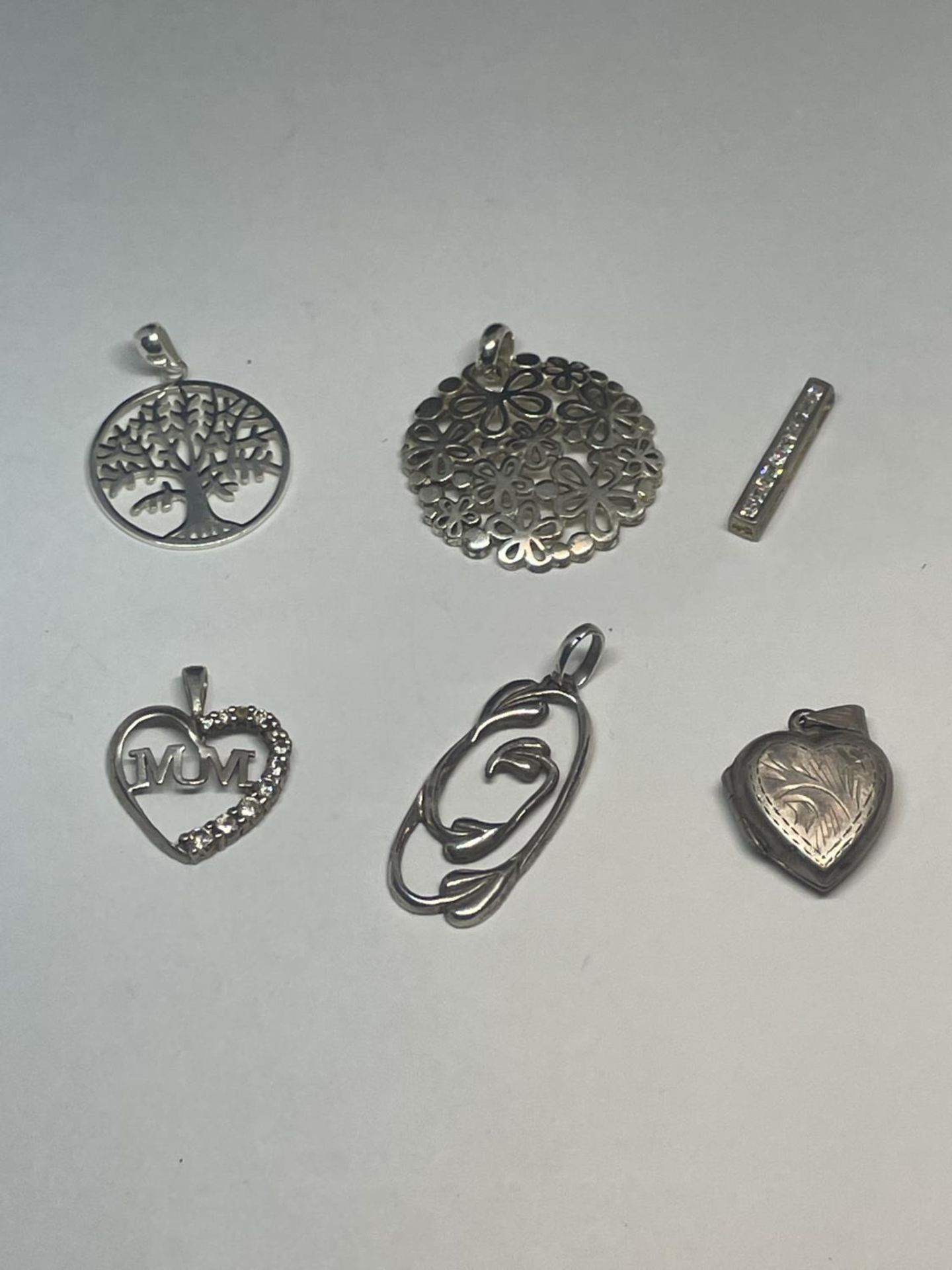 SIX SILVER PENDANTS