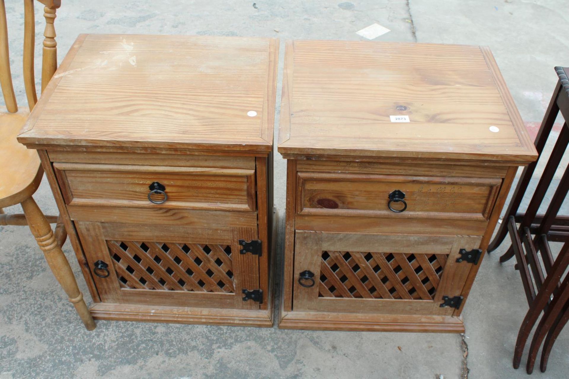 A PAIR OF MEXICAN PINE BEDSIDE CUPBOARDS WITH LATTICE WORK DOORS