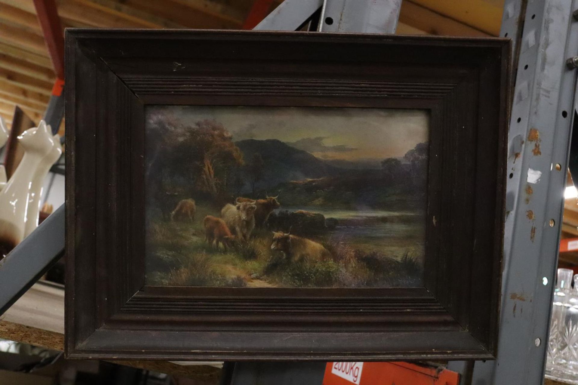 A FRAMED PRINT OF A COUNTRY CATTLE SCENE