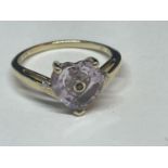 A 9 CARAT GOLD RING WITH A HEART SHAPED AMETHYST AND TWO DIAMONDS SIZE N/O