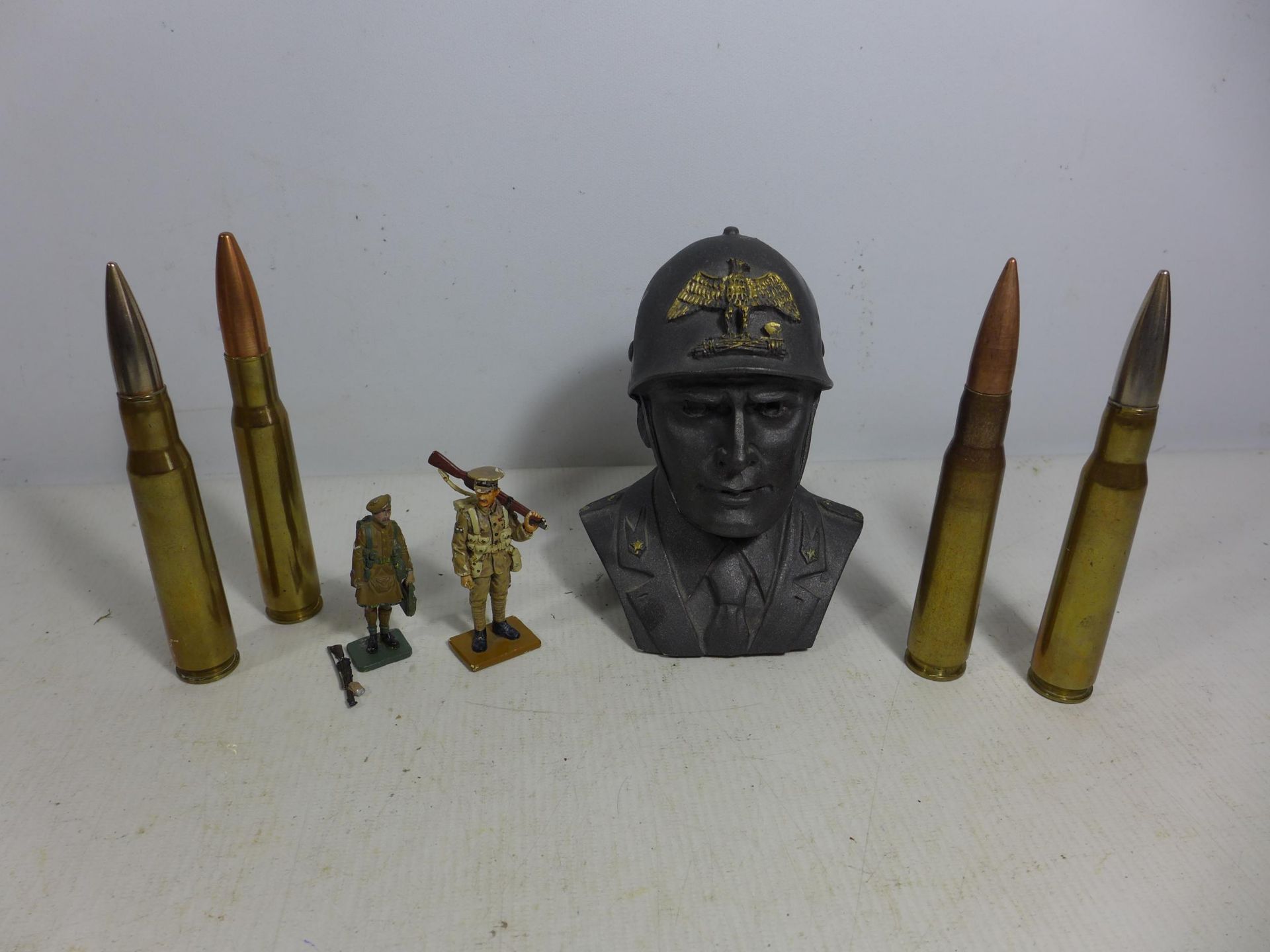 FOUR INERT CANNON SHELLS, TWO MODEL SOLDIERS AND A BUST OF AN ITALIAN SOLDIER
