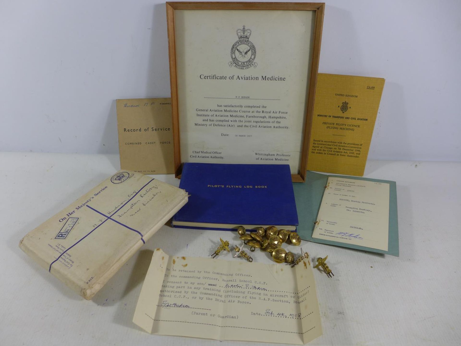 A COLLECTION OF RAF EPHEMERA FROM FLIGHT LIEUTENANT M.F.HUDSON COMPRISING OF BUTTONS, PILOTS LOG