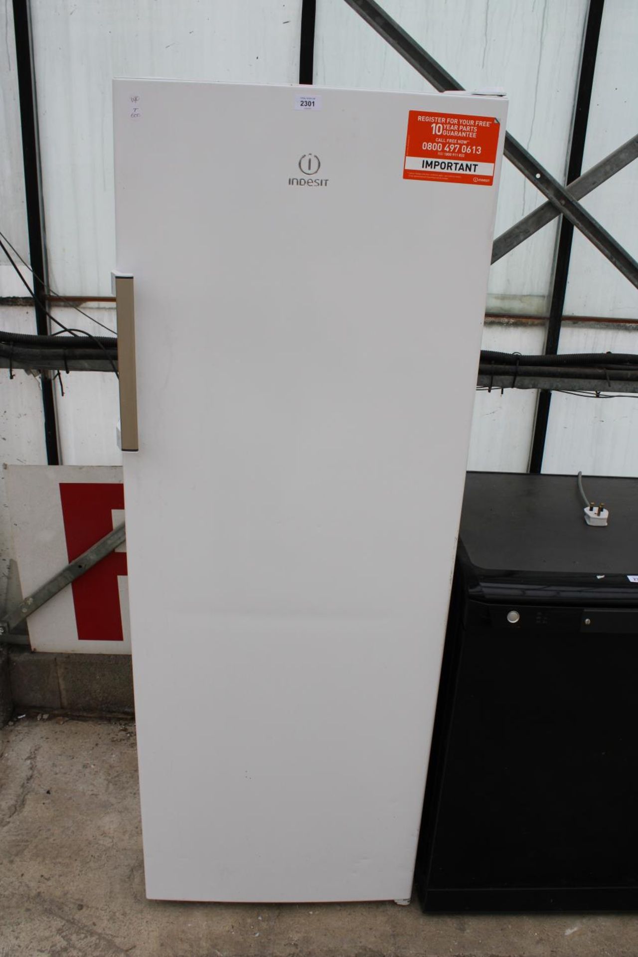 A WHITE INDESIT UPRIGHT FRIDGE BELIEVED IN WORKING ORDER BUT NO WARRANTY
