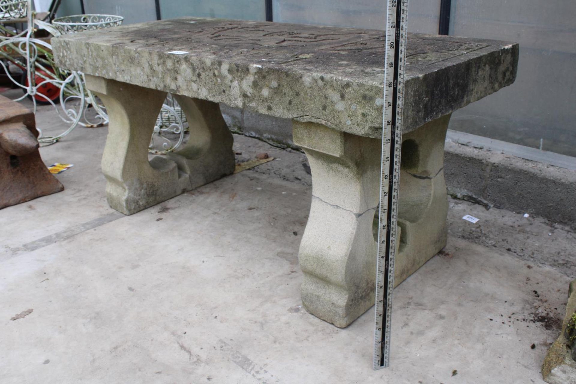 A NATURAL STONE HAND CARVED BENCH WITH 'THE JOKER' DETAIL AND PEDESTAL BASES (REQUIRES FIXING ONTO - Image 2 of 6