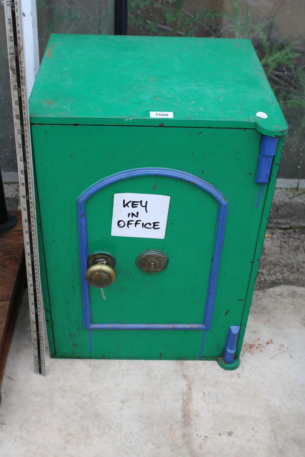 A VINTAGE HEAVY CAST IRON SAFE WITH KEY IN THE OFFICE