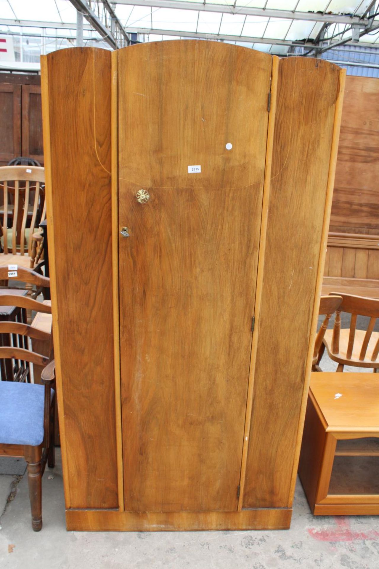 A MID TWENTIETH CENTURY WALNUT SINGLE DOOR WARDROBE