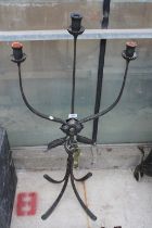 A DECORATIVE THREE BRANCH METAL CANDLESTICK