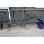 A METAL GARDEN CHAIR WITH RATTAN SEAT AND BACK AND A SIMILAR HEAVY METAL BENCH