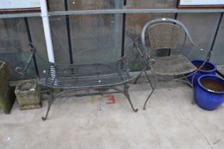 A METAL GARDEN CHAIR WITH RATTAN SEAT AND BACK AND A SIMILAR HEAVY METAL BENCH