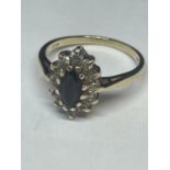 A 9 CARAT GOLD RING WITH CENTRE SAPPHIRE SURROUNDED BY CUBIC ZIRCONIAS SIZE N/O