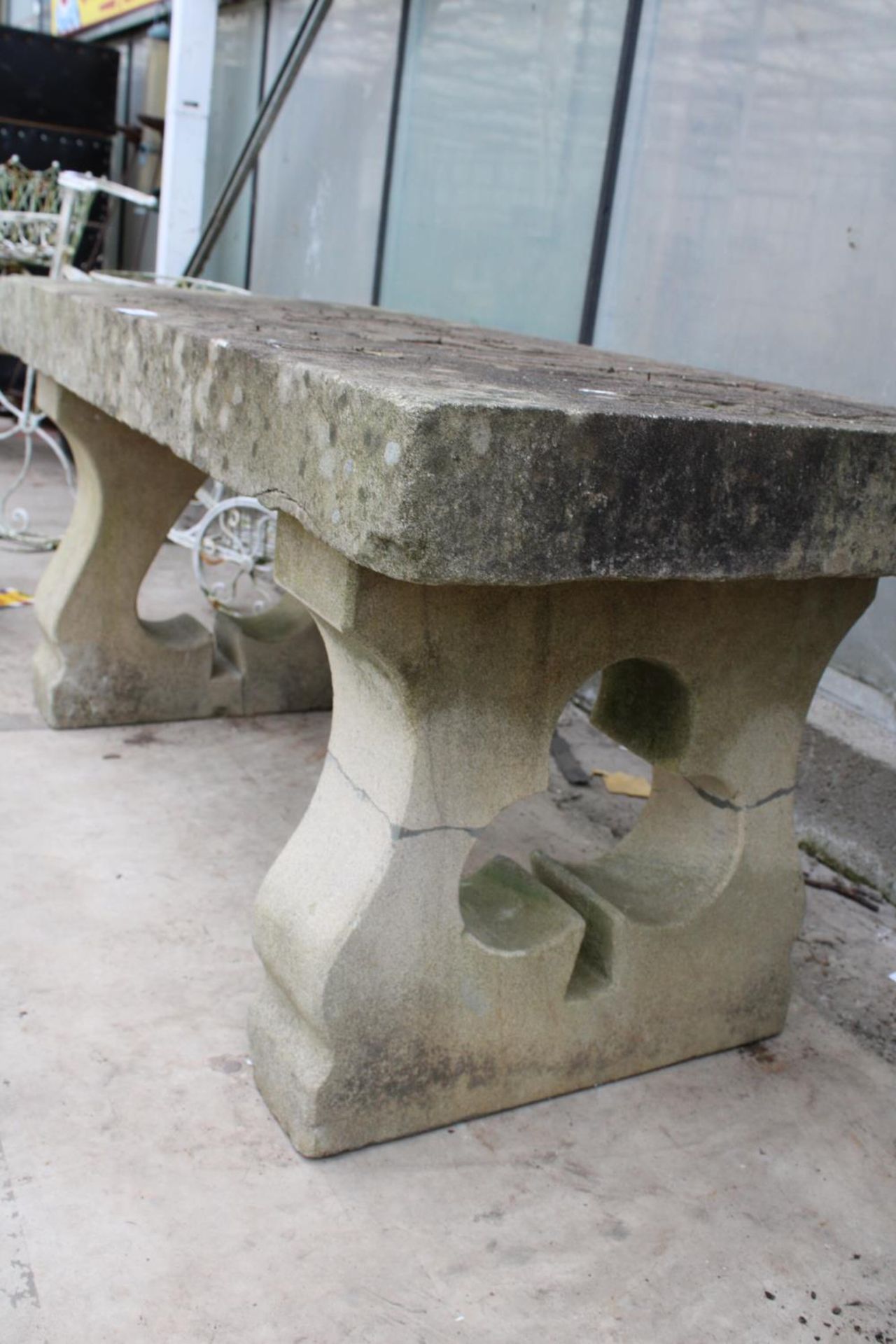 A NATURAL STONE HAND CARVED BENCH WITH 'THE JOKER' DETAIL AND PEDESTAL BASES (REQUIRES FIXING ONTO - Image 3 of 6