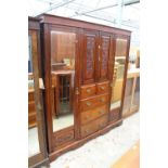 A LATE VICTORIAN MAHOGANY DOUBLE MIRROR-DOOR WARDROBE ENCLOSING 2 CUPBOARDS, 2 SHORT AND 3 LONG