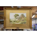 A GLIT FRAMED WATERCOLOUR OF A COUNTRY COTTAGE SCENE