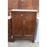 A CHINESE ELM TAPERING TWO DOOR CABINET WITH BRASS HANDLES AND LOCK WITH TWO INTERNAL DRAWERS, 36"
