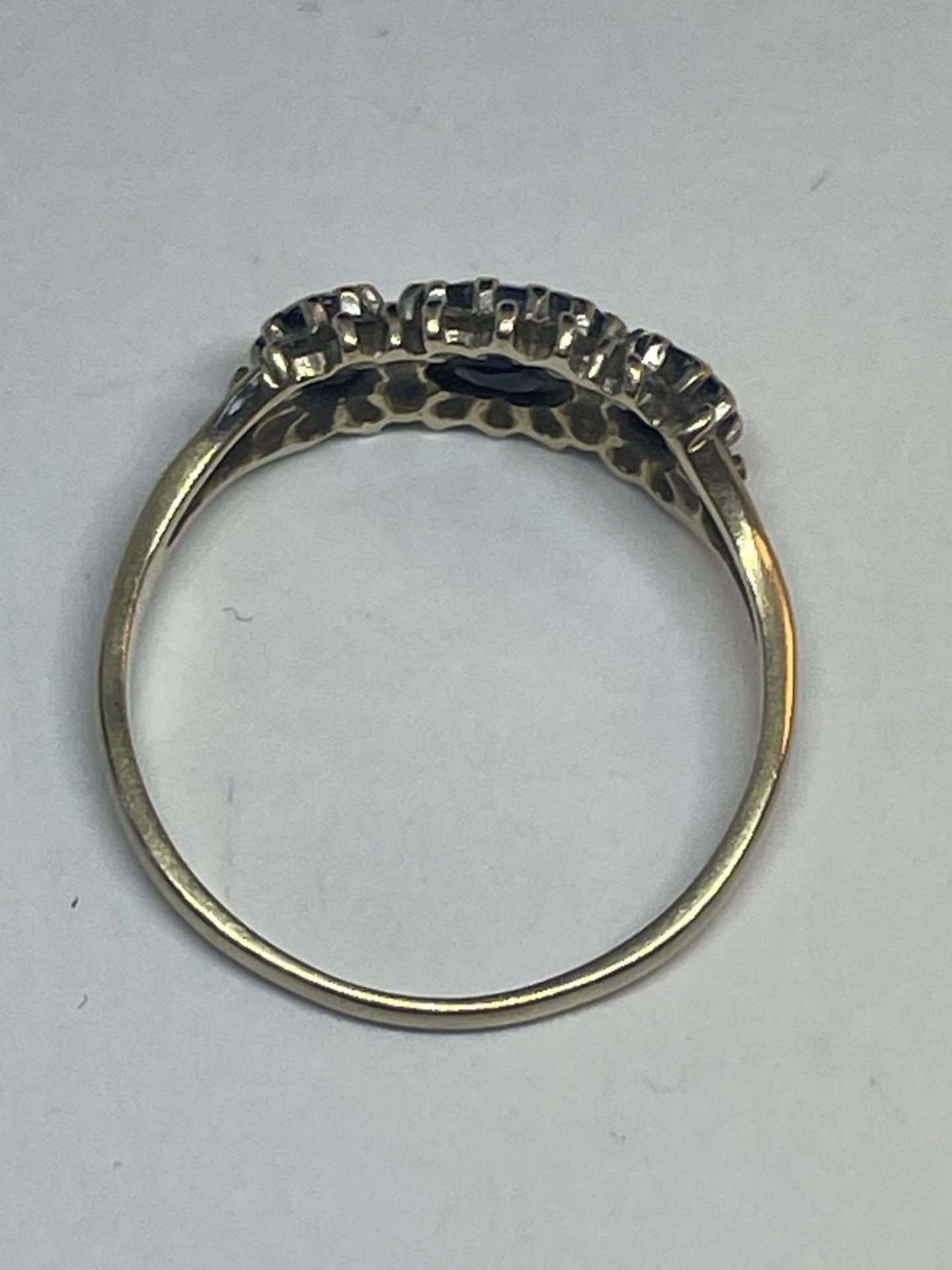 A 9 CARAT GOLD RING WITH THREE IN LINE SAPPHIRES SURROUNDED BY CUBIC ZIRCONIAS SIZE Q - Image 3 of 3