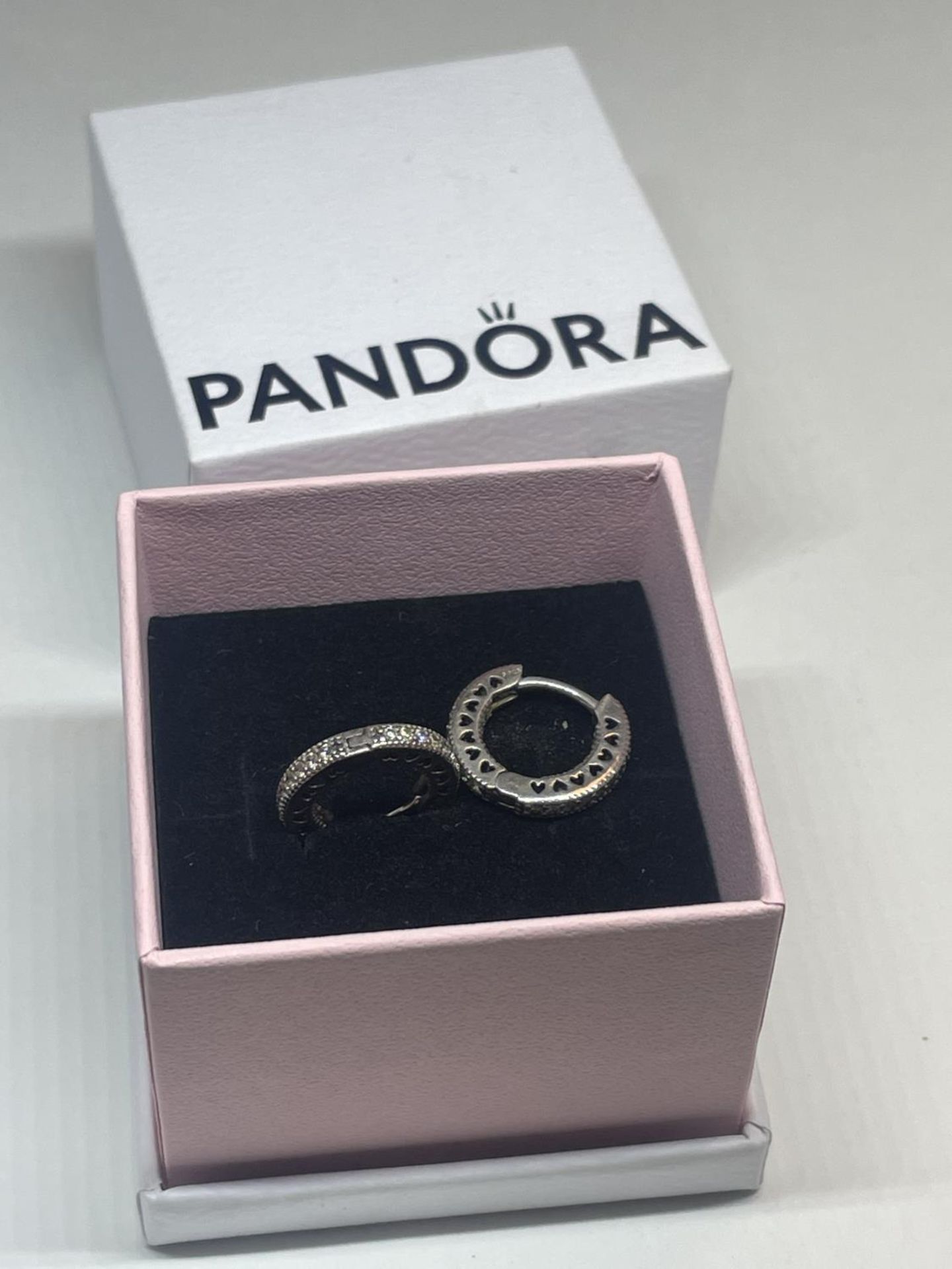 A PAIR OF SILVER PANDORA EARRINGS IN A PRESENTATION BOX