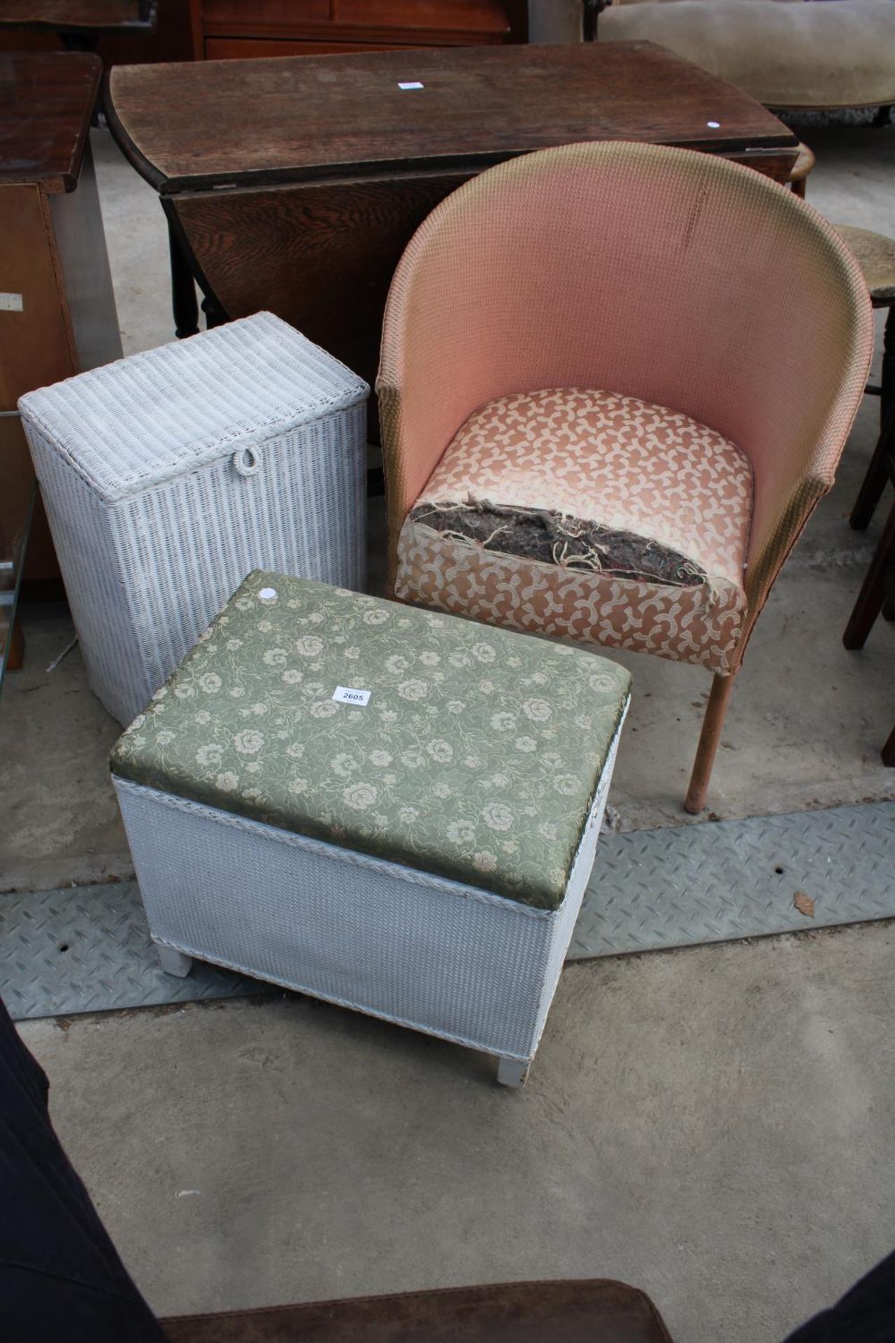 A LLOYD LOOM LINEN BASKET, LLOYD LOOM STYLE OTTOMAN AND CHAIR