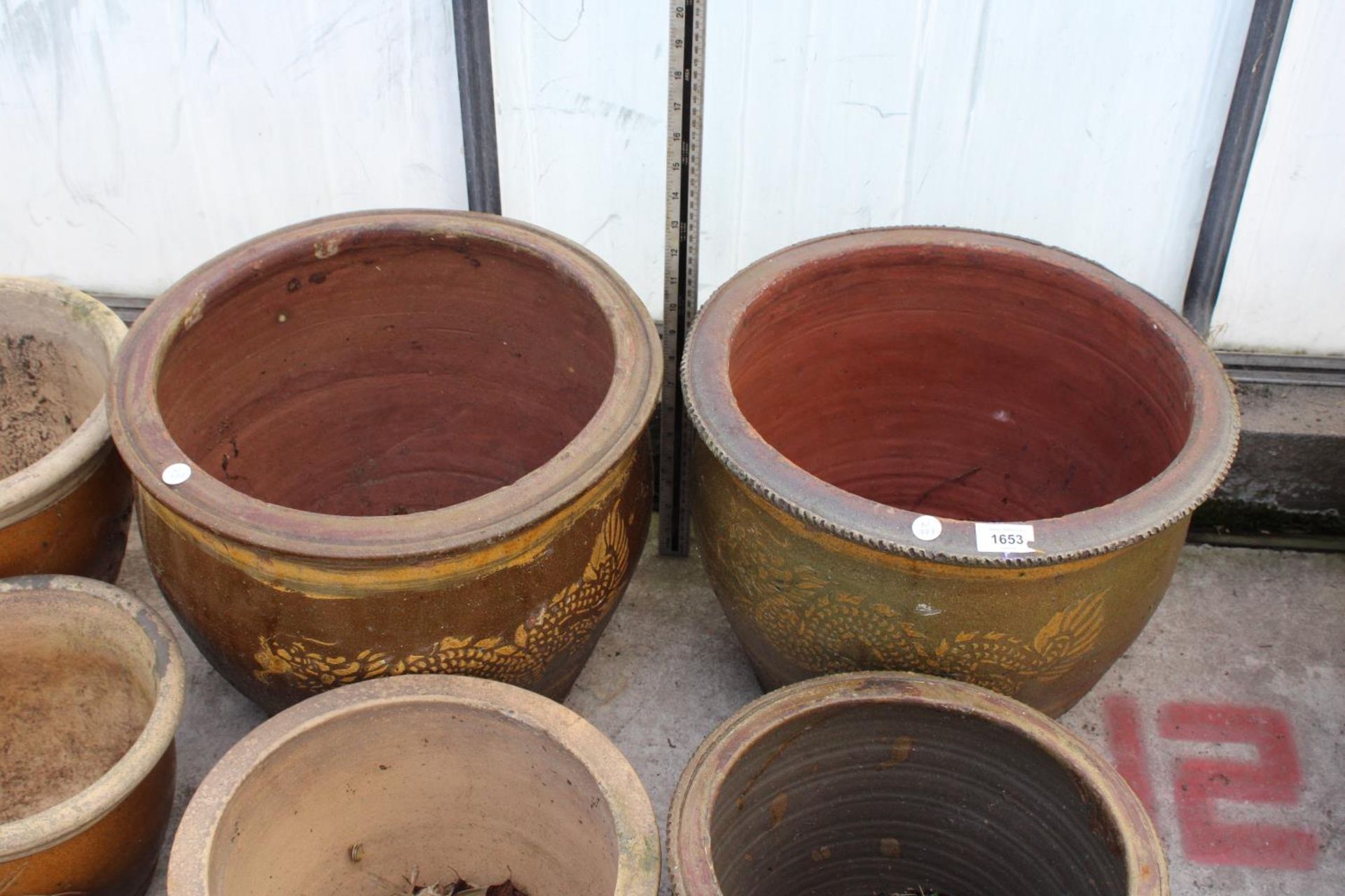 AN ASSORTMENT OF VARIOUS SIZED BROWN GLAZED GARDEN POTS, SOME DEPICTING DRAGONS - Image 2 of 3