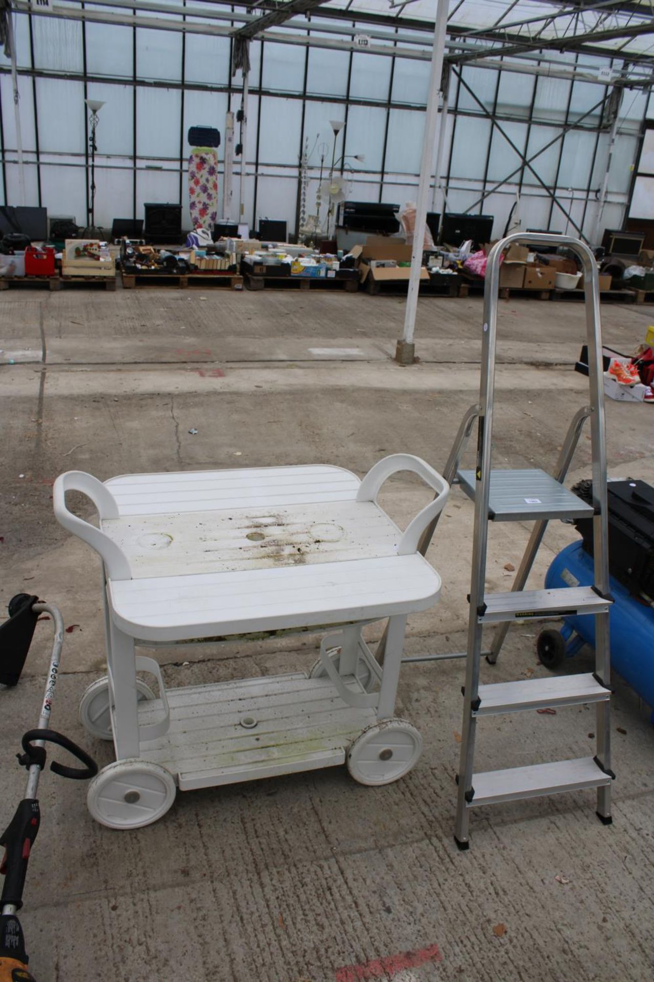 A THREE RUNG ALUMINIUM STEP LADDER AND A PLASTIC DRINKS TROLLEY