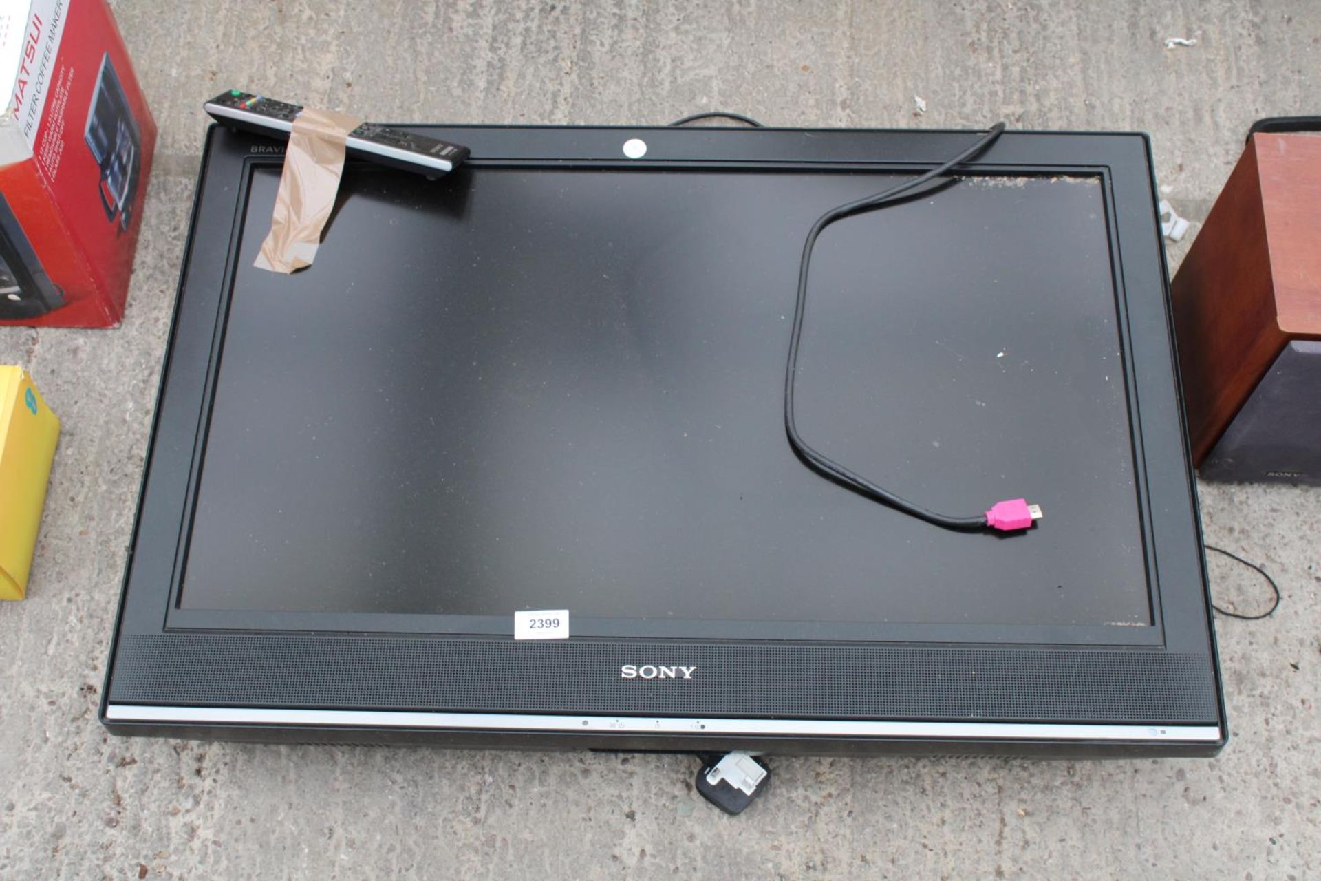 A SONY TELEVISION WITH REMOTE CONTROL
