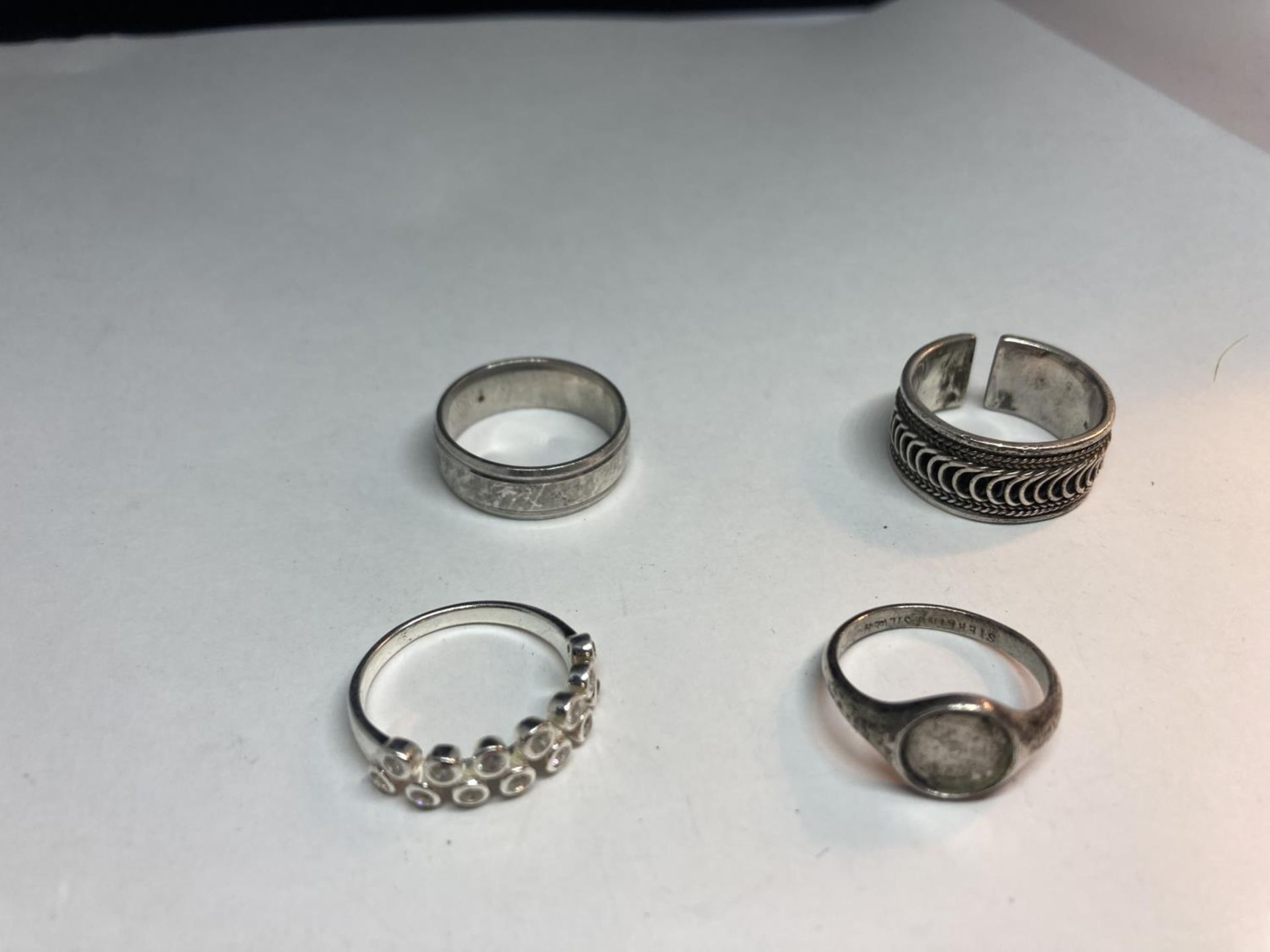 FOUR VARIOUS SILVER RINGS