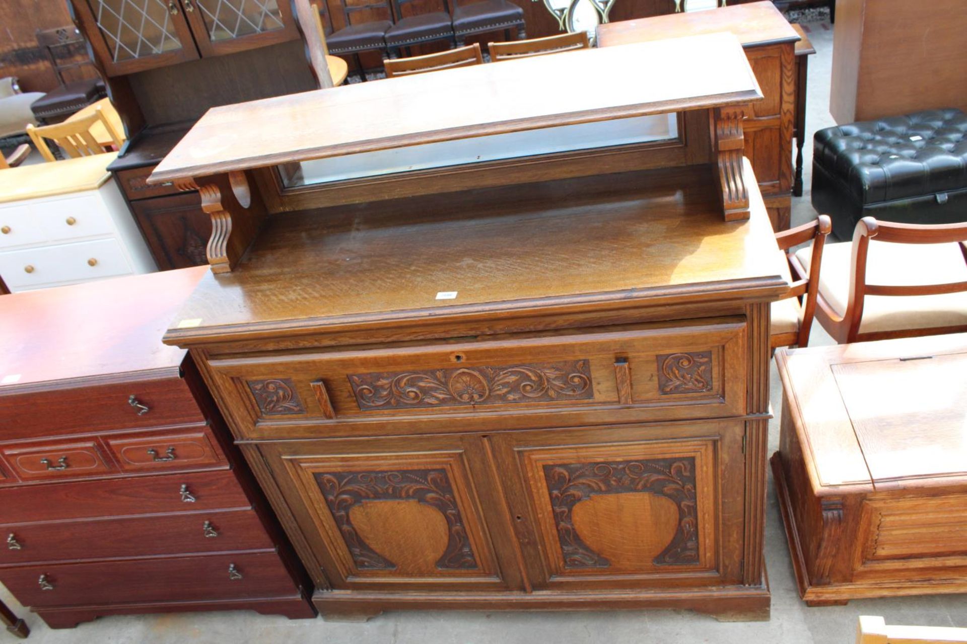 AN OAK ART NOUVEAU INFLUENCE SIDEBOARD/SECRETAIRE WITH FITTED INTERIOR, LOW MIRROR-BACK AND CARVED