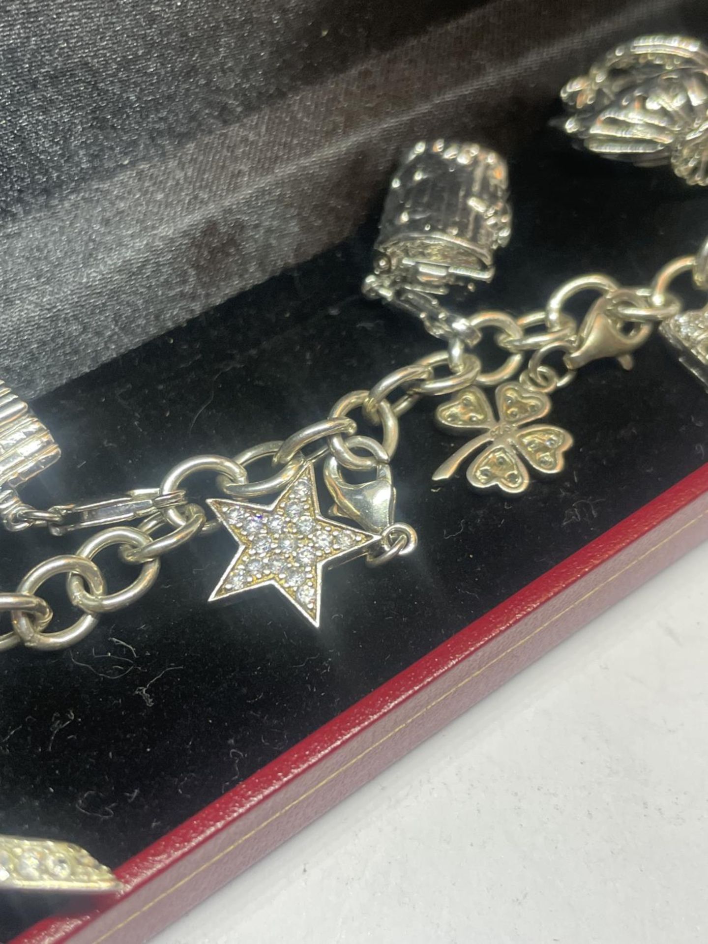 A SILVER CHARM BRACELET WITH NINE CHARMS IN A PRESENTATION BOX - Image 3 of 4