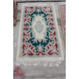 A CREAM PATTERNED FRINGED RUG