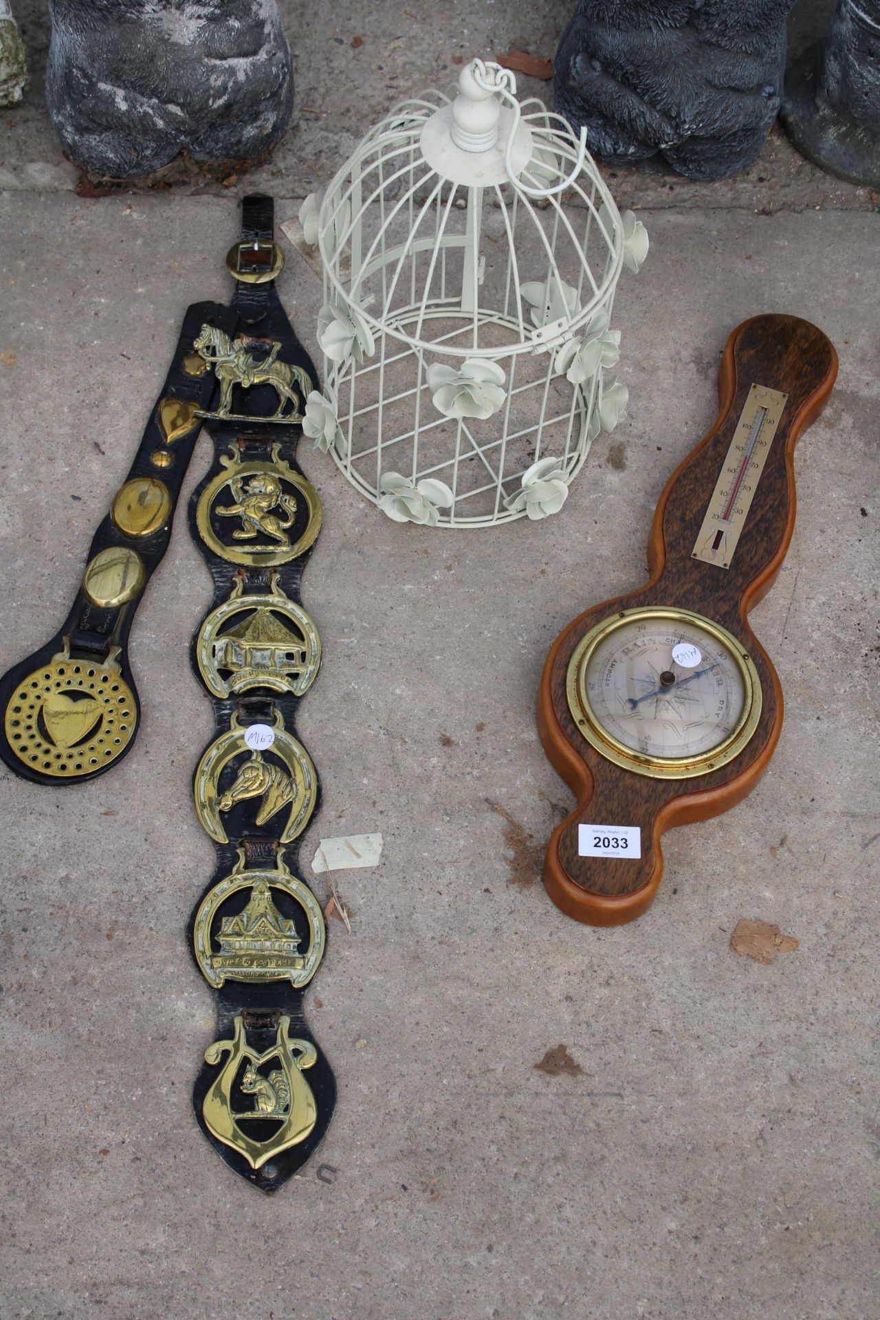 THREE ITEMS TO INCLUDE A BAROMETER, BIRDCAGE AND HORSE BRASSES