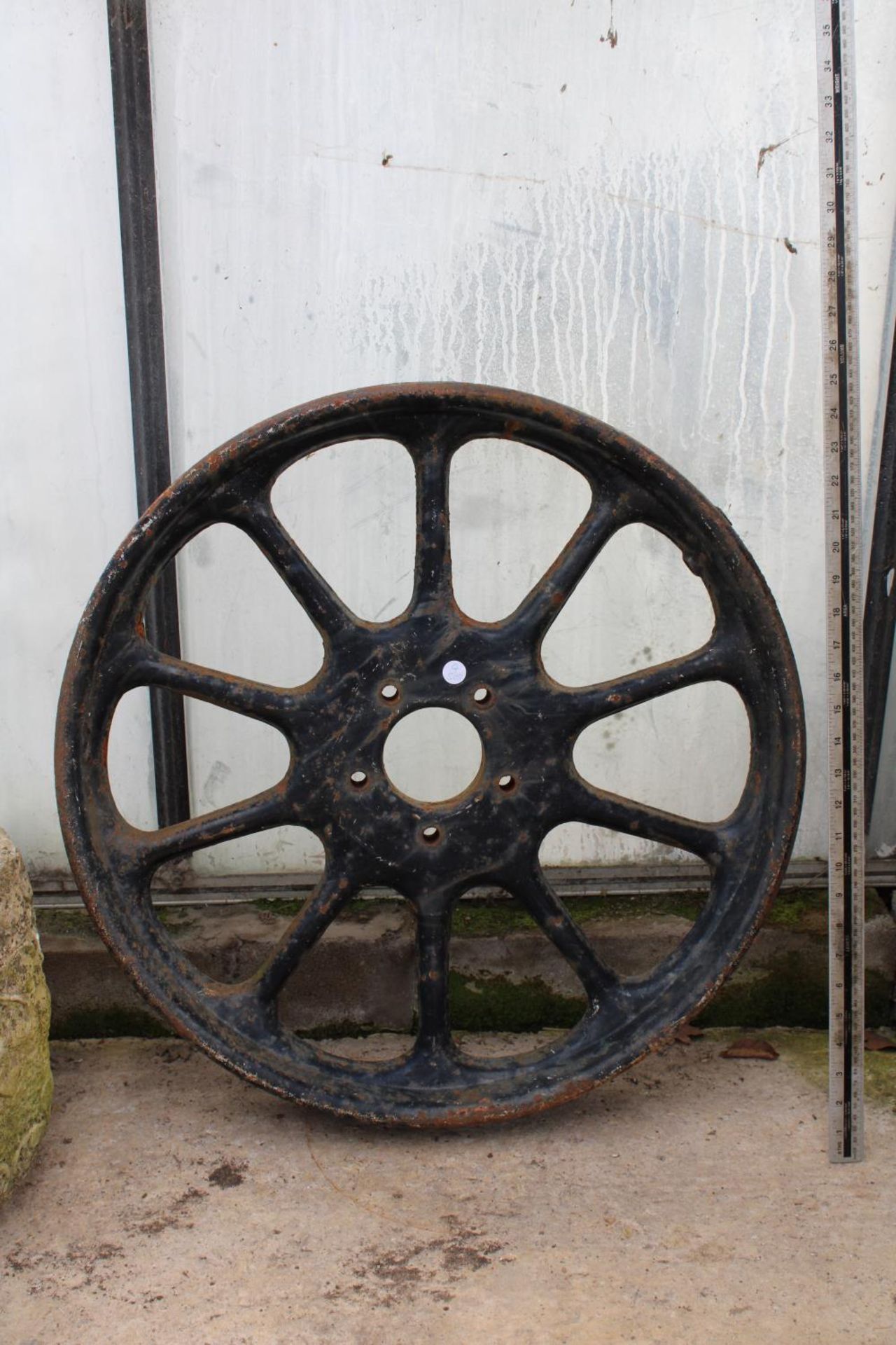 A VINTAGE CAST IRON WHEEL RIM