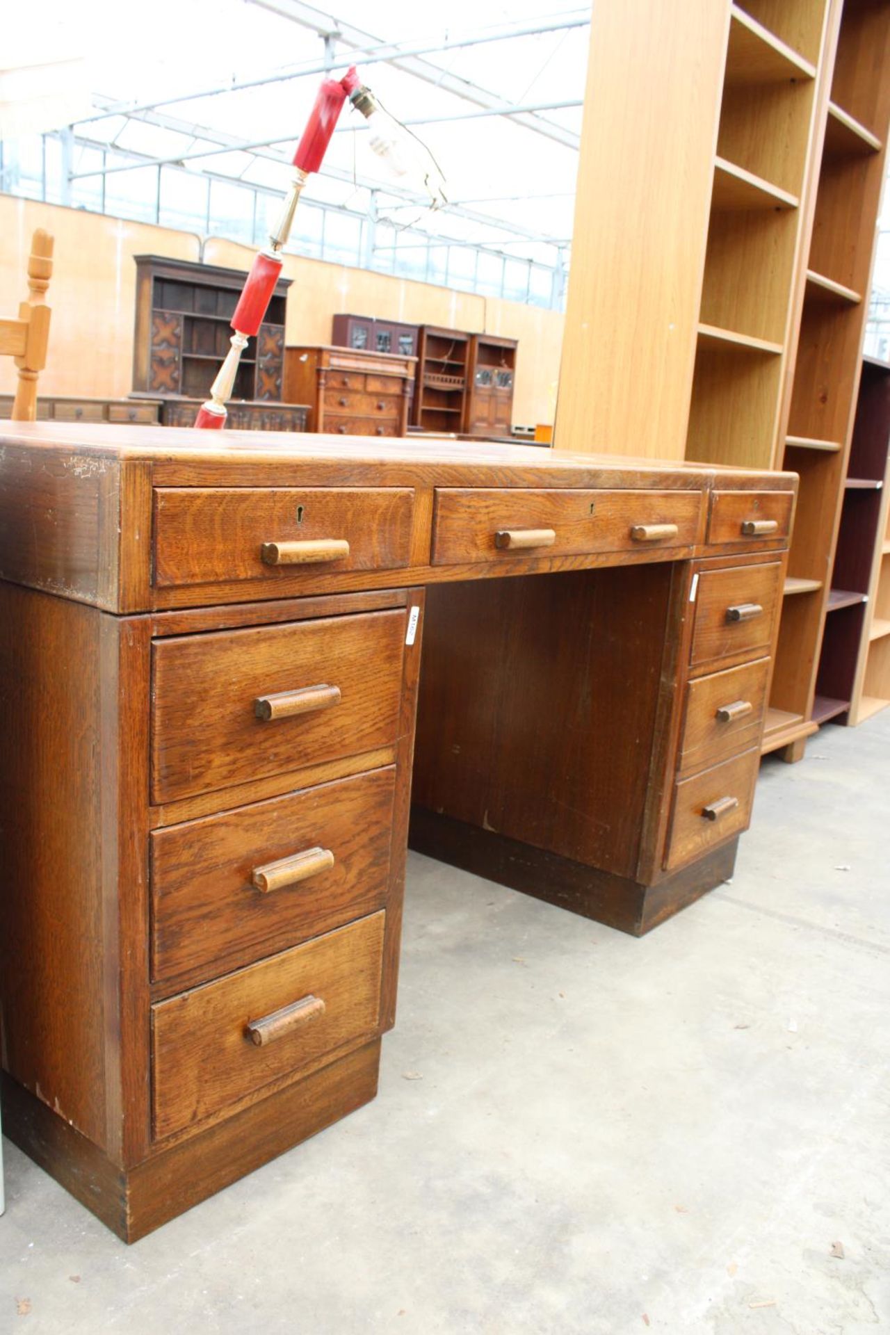A MID 20TH CENTURY OAK TWIN PEDESTAL DESK ENCLOSING 8 DRAWERS, 54" X 27" - Image 2 of 3