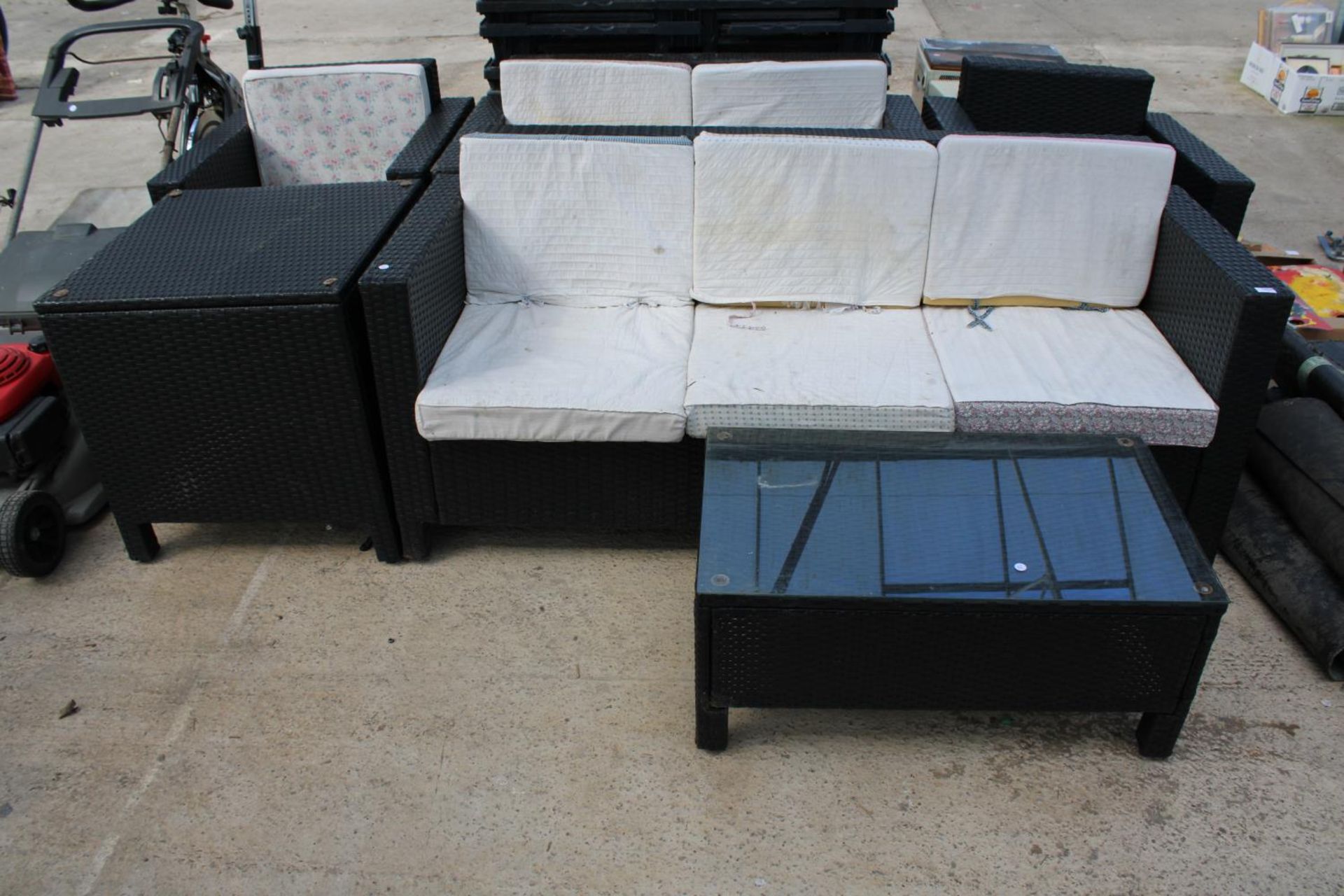 A SIX PIECE RATTAN GARDEN FURNITURE SET COMPRISING OF A THREE SEATER, A TWO SEATER, TWO CHAIRS, A