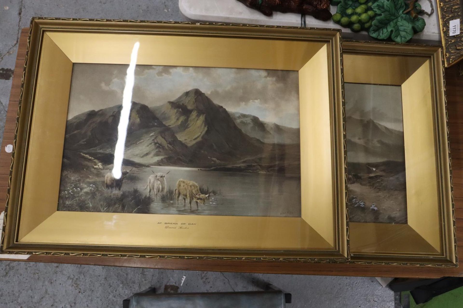 A PAIR OF GILT FRAMED PRINTS BY DAVID HICKS, OF HIGHLAND CATTLE IN A MOUNTAIN SETTING, 'AT BREAK