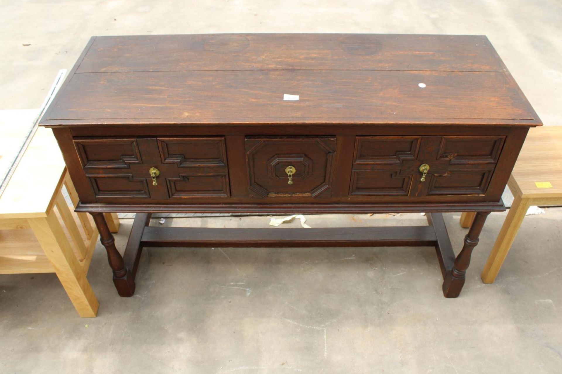 AN OAK JACOBEAN STYLE THREE DRAWER DRESSER BASE ON TURNED LEGS, 49.5" WIDE