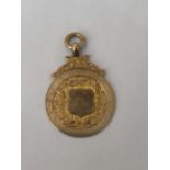 A HALLMARKED 9CT GOLD BIRMINGHAM SPORTING FOB INSCRIBED "DEVON WED LEAGUE CUP WINNERS 1925-26 S.