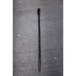 AN ETHNIC AFRICAN BLACK WOODEN SPEAR - WITH CARVED HEAD DECORATION TO THE TOP