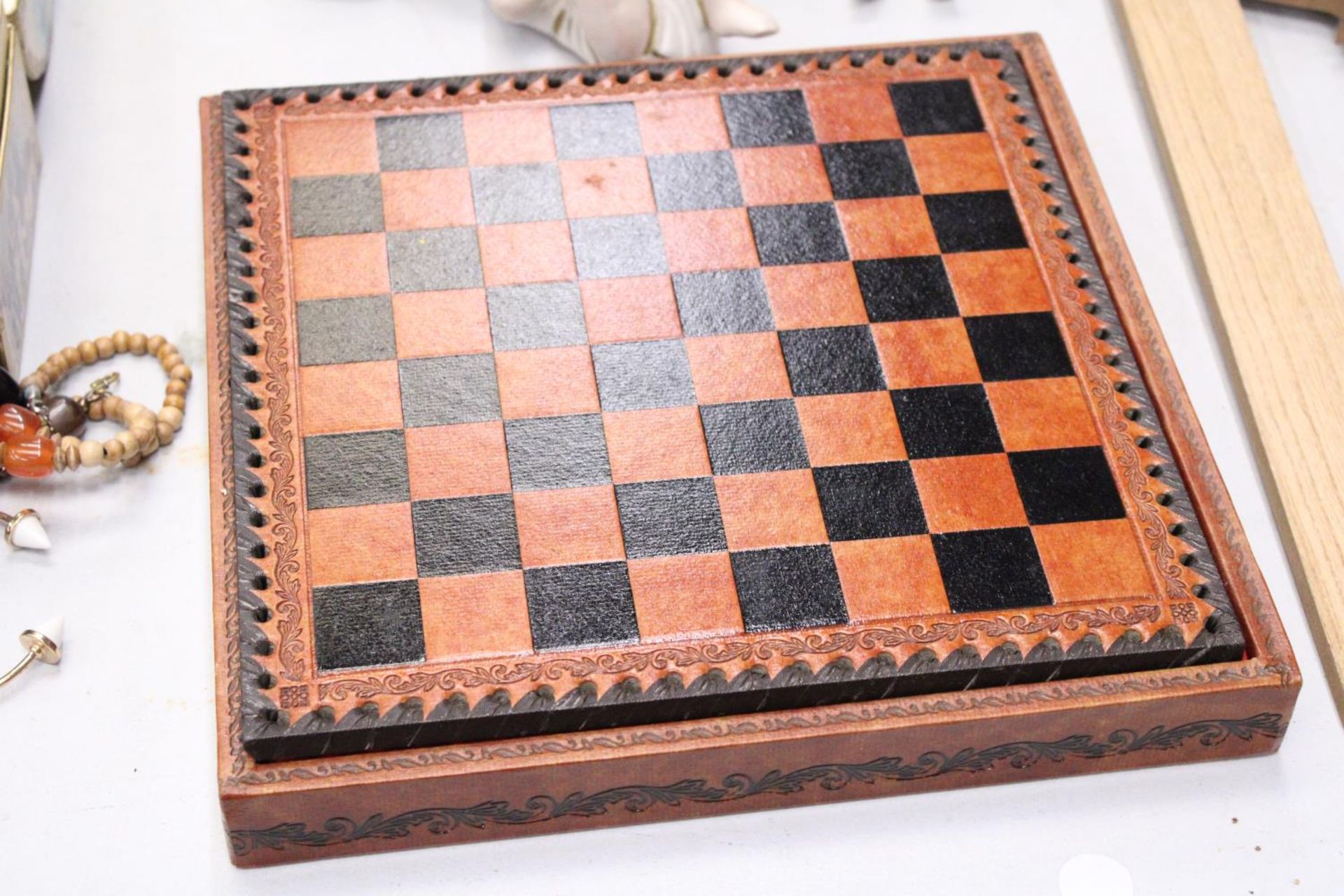A LEATHERBOUND CHESS BOARD WITH METAL CHESS PIECES - COMPLETE