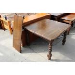AN EARLY 20TH CENTURY OAK EXTENDING DINING TABLE ON BARLEY-TWIST LEGS WITH CANTED CORNERS, 41"